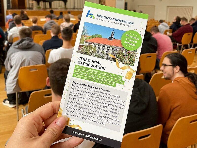 Enrolment flyer in front of an audience